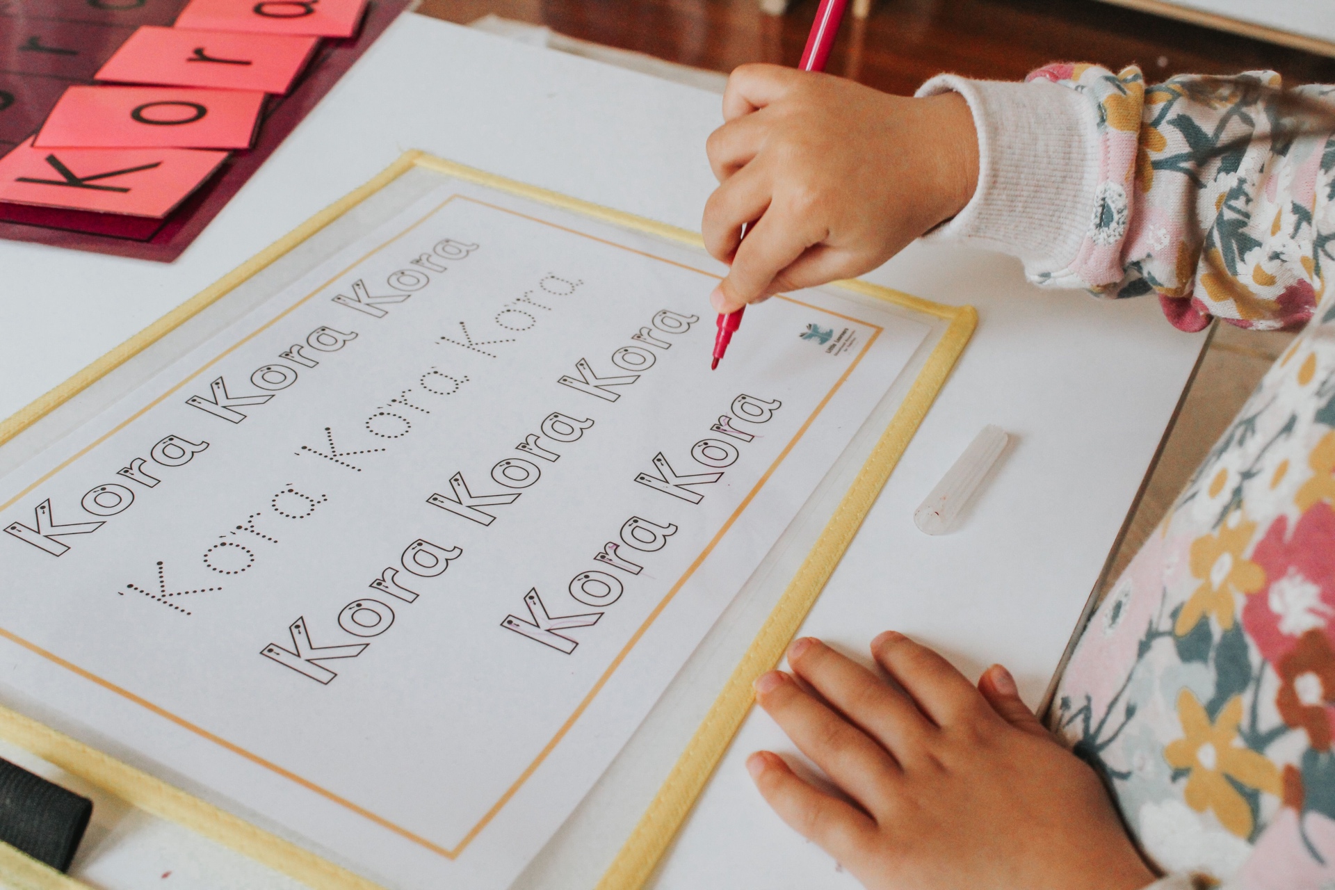 Kora practising letter tracing